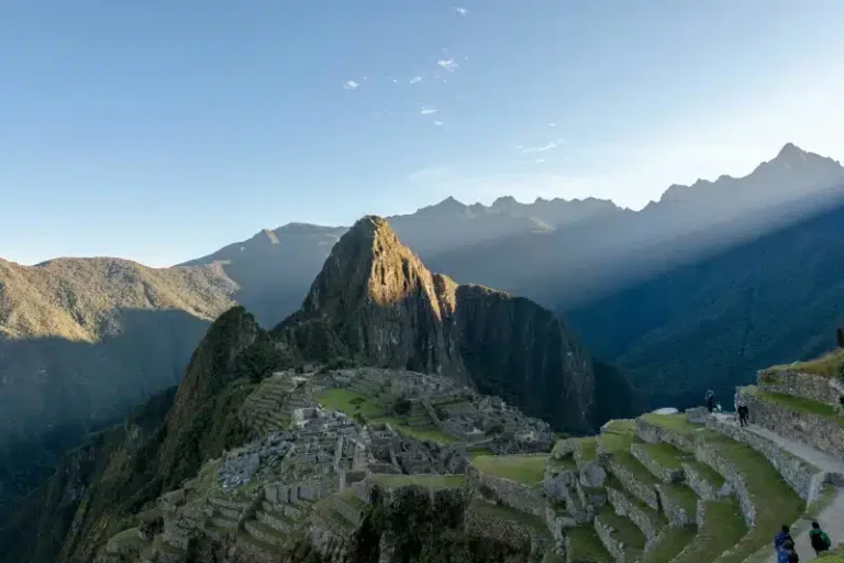 Sunlit view of Machu Picchu with Huayna Picchu in the background, marking the final arrival of the Short Inca Trail after Sacred Valley exploration