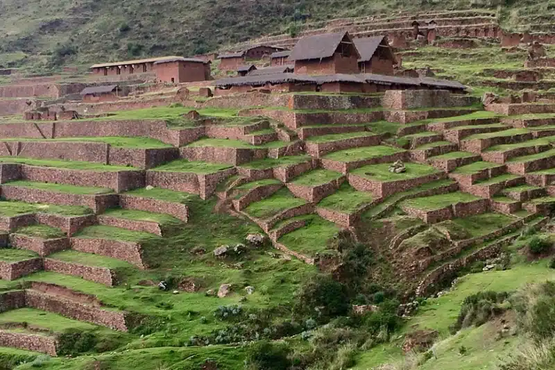 Ancient Inca agricultural terraces and traditional buildings at Pisac, a key site to visit on a Short Inca Trail Sacred Valley extension - Peru Hikers.