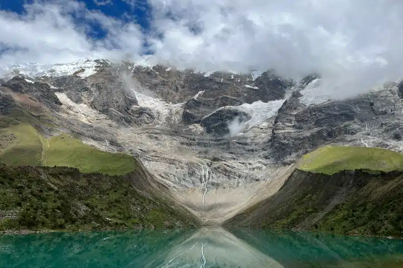 Turquoise Humantay Lake beneath snow-capped peaks and cascading meltwater, showcasing Peru’s high-altitude alpine scenery