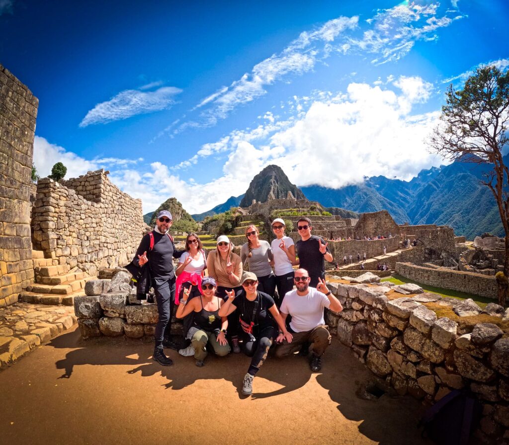 Hiker and guide celebrate their success at Machu Picchu, a journey made possible by respectful and fair tipping in Peru - Peru Hikers
