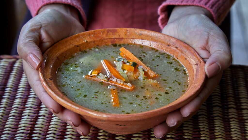 A bowl of nutritious Andean soup, a perfect meal for acclimatization during training for high altitude trekking in Peru - Peru Hikers