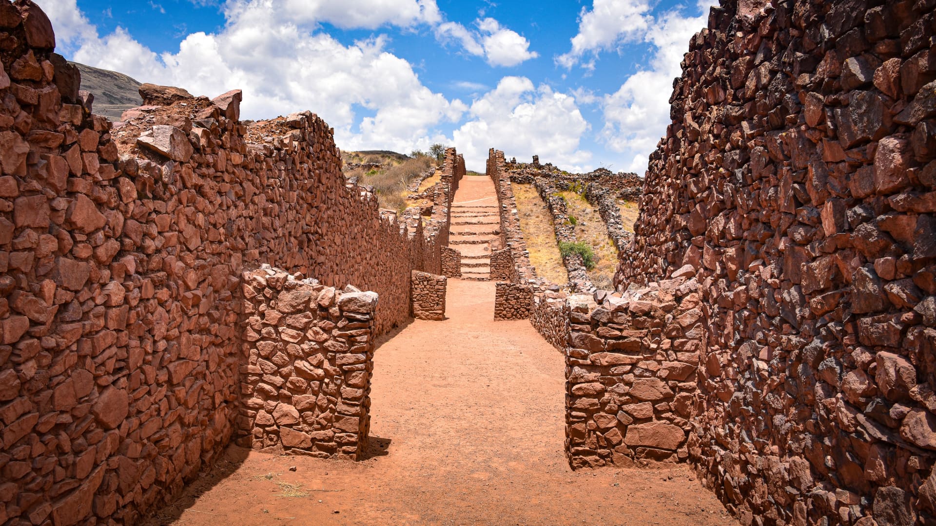 Walking through the ancient corridors of Pikillacta, a pre-Inca city on the South Valley Cusco Tour.