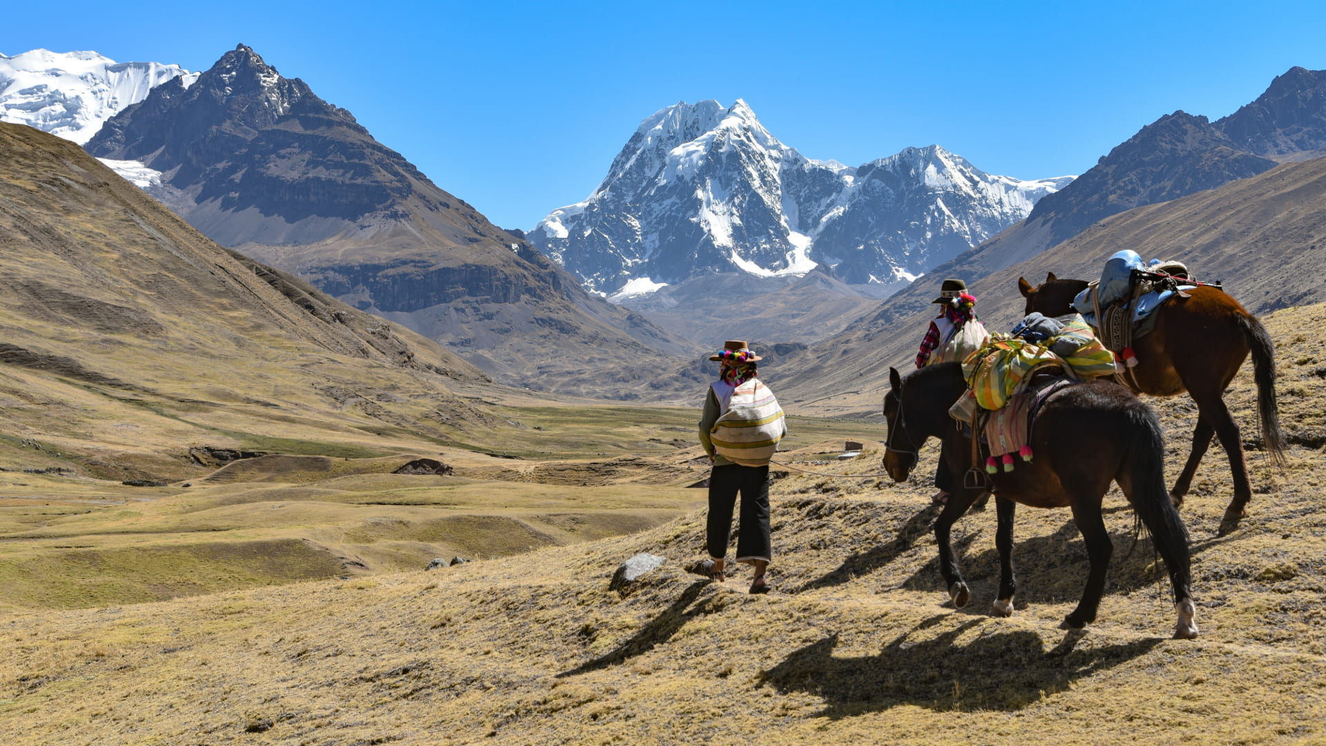 Close-up of Peruvian Soles (PEN) in hand, demonstrating the cash needed for tipping in Peru on treks and tours - Peru Hikers
