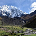 Trekkers celebrating at the snowy Salkantay Pass summit, the highest of the salkantay trek photo spots.